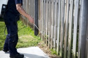 Pest Control Worker Spraying Pesticide outside the house