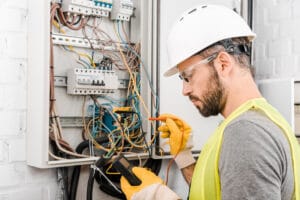 Electrician using a multimeter.